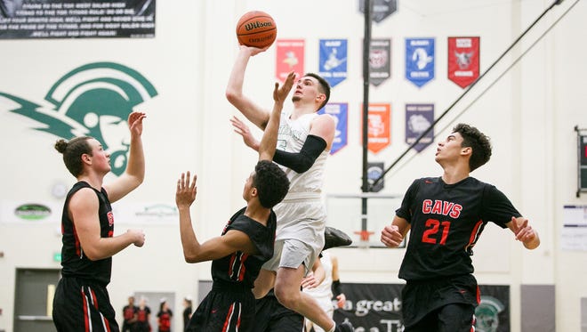 West Salem's Kyle Greeley (5) goes up for a basket in a first-round playoff game against Clackamas on Wednesday, Feb. 28, 2018, at West Salem High School. The Titans won the game 88 to 69. 