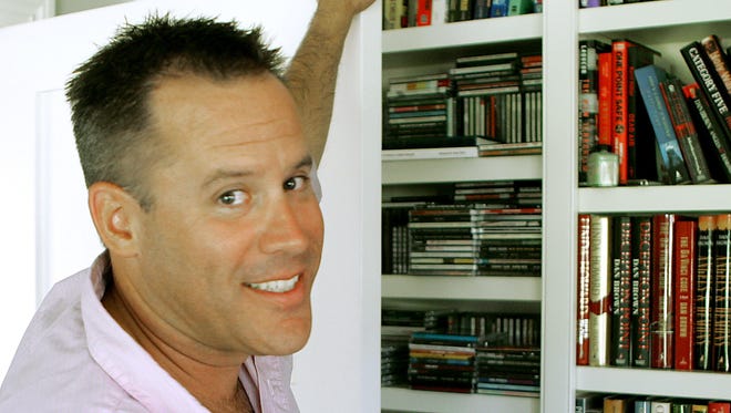 This Sept. 2, 2005 file photo shows best-selling author Vince Flynn in the library of his Edina, Minn. home.  The late Minnesota author's counterterrorism operative Mitch Rapp is coming to the big screen in September. CBS Films and Lionsgate announced Wednesday, March 22, 2017 that “American Assassin,” based in Flynn’s best-seller, will hit theaters nationwide and in North America on Sept. 15. Flynn wrote a series of thrillers featuring Rapp. He died in 2013 after battling prostate cancer.
