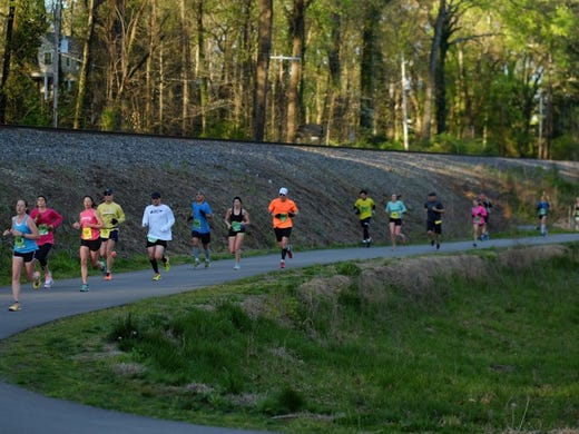 Runners make their way down Third Creek Greenway around mile marker 9 during the 2016 Covenant Health Knoxville Marathon on Sunday, April 3, 2016. 