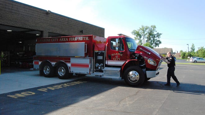 Chief Joe Slankster closes the hood of the Marine City Fire Authority's new tanker truck in 2015. The truck cost $219,000 and holds 3,000 gallons of water.