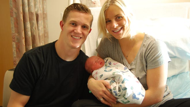 Parents Clint and Alexa Feinauer hold their newborn son Champ, who was born at 1:02 a.m. on New Year's Day as the first baby of the new year in Cedar City.
