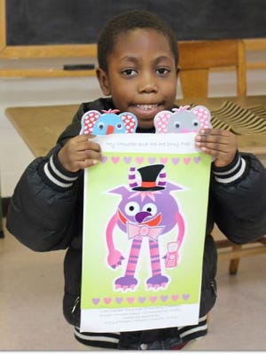 Anton Winrow, a student at Quarter Mile Lane School, shows off his creation from a “Loving Literacy” event at Bridgeton Public Library.