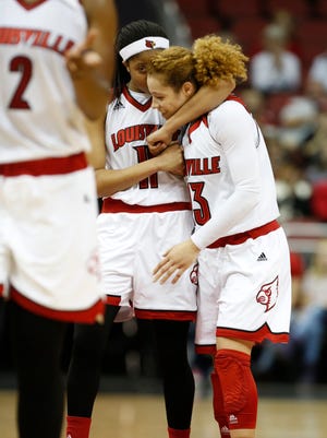 Louisville's Briahanna Jackson, right is hugged by teammate Arica Carter after leading her team in a comeback victory over IUPUI. Dec. 13, 2015.