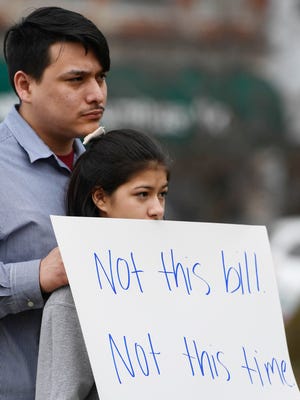 Jesse Gonzales and Brianna Gracia hold signs at a rally for education held at the Henderson County Courthouse steps Thursday, March 9, 2017.