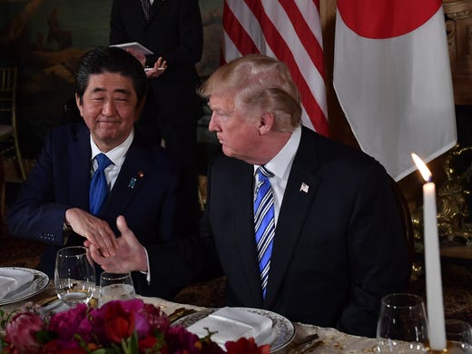 Japan's Prime Minister Shinzo Abe shakes hands with