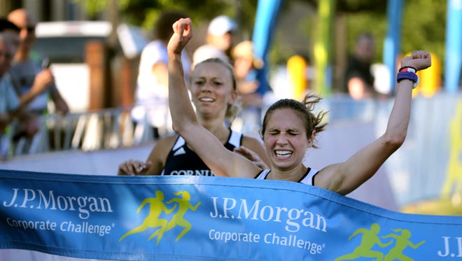 Trisha Byler (right) comes from behind to nip  Ashley Nevol by .05  and win the women's division of the JP Morgan Corporate Challenge with a time of 20:25.