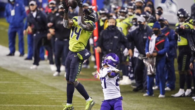 Seattle receiver DK Metcalf pulls in a long pass on the Seahawks' last series of a 27-26 victory over Minnesota on Sunday night. The Vikings went for broke on fourth-and-1 and came up short, setting the stage for Seattle's winning drive.