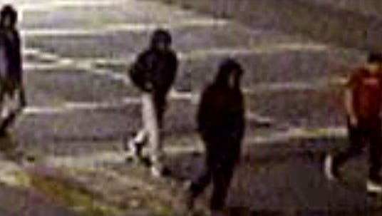 A surveillance photo shows four men suspected of attacking two University of Delaware students Sunday morning.
