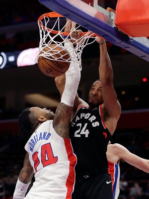 Toronto Raptors swingman Norman Powell dunks on Detroit Pistons forward Eric Moreland during the second half Wednesday, March 7, 2018 in Detroit.