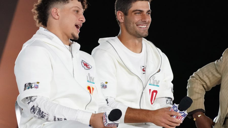 Jan 27, 2020; Miami, FL, USA; Kansas City Chiefs quarterback Patrick Mahomes (left) and San Francisco 49ers quarterback Jimmy Garoppolo (right) are interviewed on stage during Super Bowl LIV Opening Night at Marlins Park.  Mandatory Credit: Kirby Lee-USA TODAY Sports
