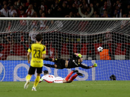 Monaco's Radamel Falcao, center below, heads the ball to score the team's second goal during the Champions League quarterfinal second leg soccer match between Monaco and Dortmund at the Louis II stadium in Monaco, Wednesday April 19, 2017. (AP Photo/Claude Paris)