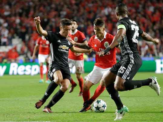 Benfica's Alejandro Grimaldo, center, fights for the ball with Manchester United's Ander Herrera, left, during their Champions League group A soccer match between Manchester United and Benfica at Benfica's Luz stadium in Lisbon, Wednesday, Oct. 18, 2017. (AP Photo/Armando Franca)