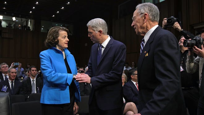 Neil Gorsuch greets Senate Judiciary ranking member Dianne Feinstein, D-Calif., and Chairman Chuck Grassley, R-Iowa, for the first day of his Supreme Court confirmation hearing on March 20, 2017.