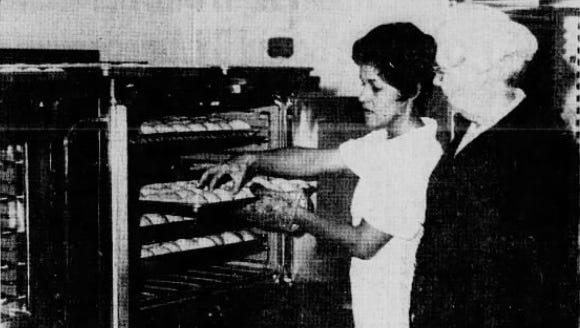 Gloria Jaramillo (left) shows Opal Haynes, director of the lunchroom program, how she'll prepare the multitude of rolls needed for the meal at the Alamogordo Junior High.