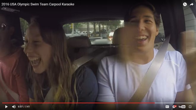 In this screenshot, U.S. Olympic team swimmers Hali Flickinger, left, and Jay Litherland laugh while singing along to the Miley Cyrus song, "Party in the USA," in a video posted on YouTube by USA Swimming. Flickinger, a Spring Grove native, and the rest of the U.S. swim team were featured in the "Carpool Karaoke"-style video in which they sing along to pop songs while driving around Atlanta.