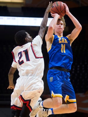 Christian Academy of Knoxville's Turner Helton (11) attempts a shot past South Doyle's Noah Wilkerson (21) during the Tennova Tip-Off Classic held at Thompson-Boling Arena on Tuesday, Nov. 8, 2016.