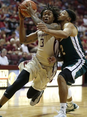 FSU's Benji Bell tries to drive past Southeastern Louisiana's Dimi Cook during their game at the Civic Center on Sunday.