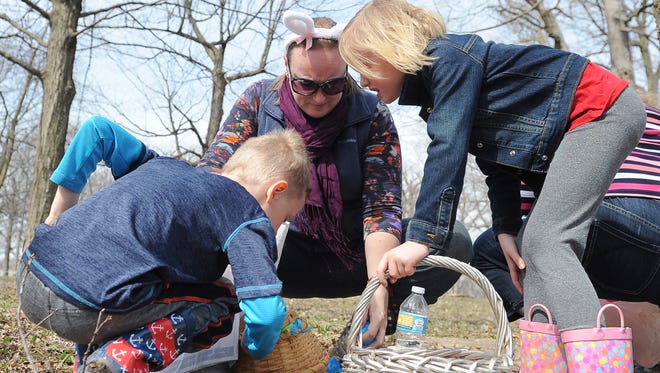 Twins Edward and Eleanor Berghammer, 6, along with their mom, Letitia Berghammer, look through their basket of eggs following the Wauwatosa Mayfair Rotary Club’s annual Easter egg hunt in April 2017. This year’s event will take place Saturday, March 31, at Wisconsin Avenue Park in Wauwatosa.