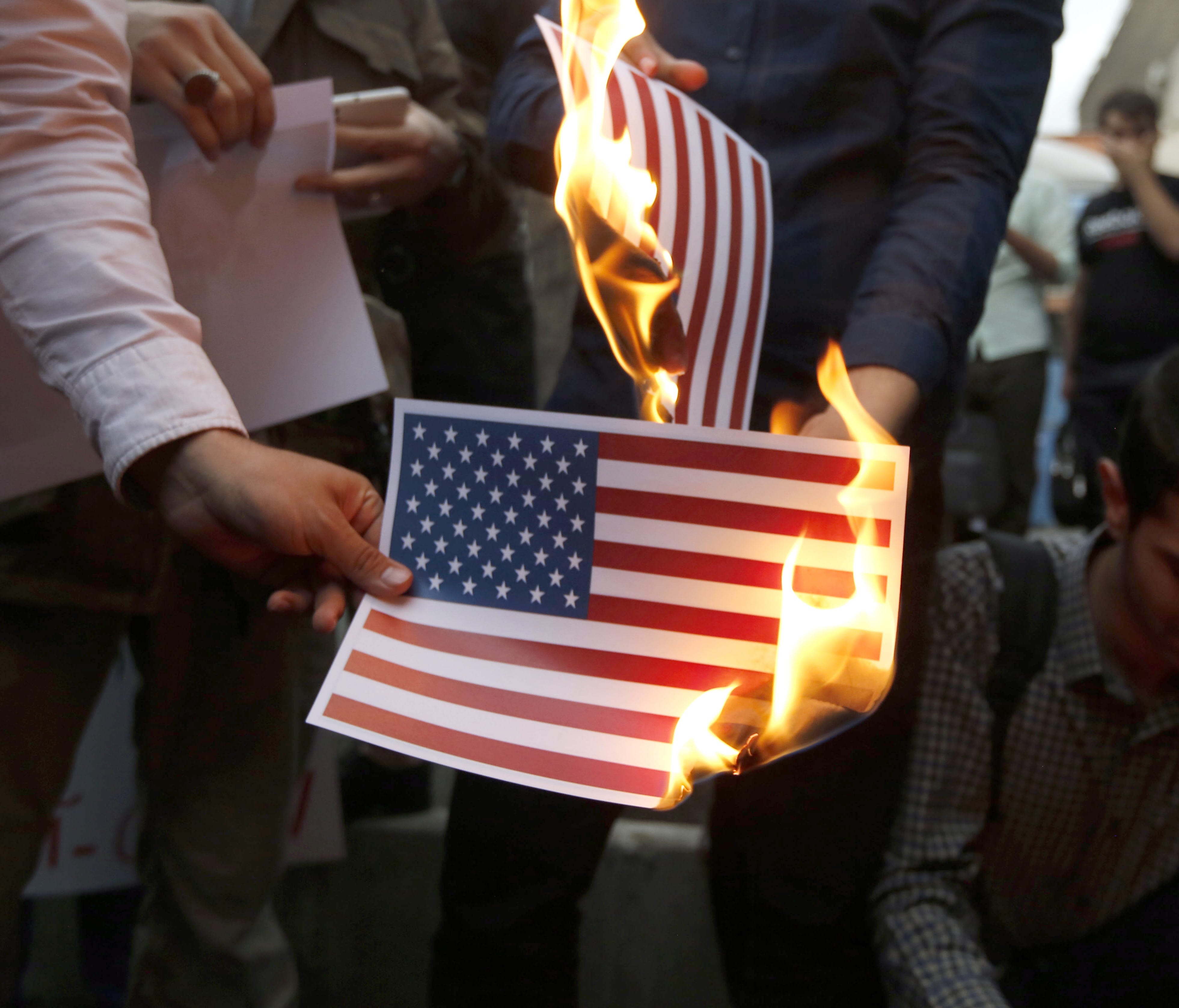 Iranians burning the American flag in Tehran on May 9, 2018.