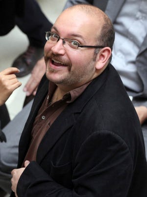 Jason Rezaian, an Iranian-American correspondent for "The Washington Post," smiles as he attends a presidential campaign event for President Hassan Rouhani in Tehran in April 2013.