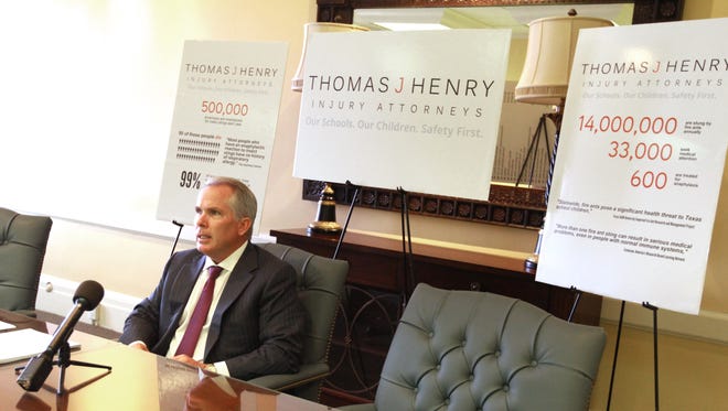 Attorney Thomas J. Henry speaks at a press conference in 2013.