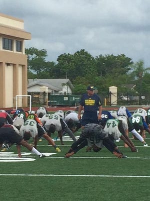 New Michigan defensive coordinator Don Brown takes inventory during Friday’s satellite camp in Ft. Lauderdale.