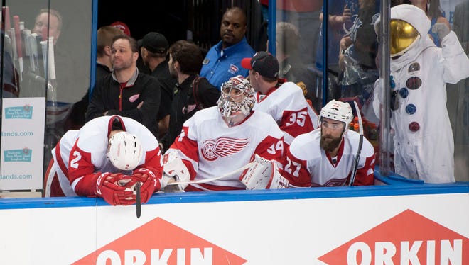Detroit's Brendan Smith, left; goalie Petr Mrazek, and Kyle Quincey sit on the bench during the final seconds of Game 5.