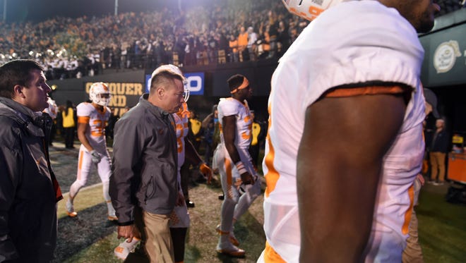 Tennessee head coach Butch Jones walks off the field following the 45-34 loss to Vanderbilt at Vanderbilt Stadium on Sunday, Nov. 27, 2016. 