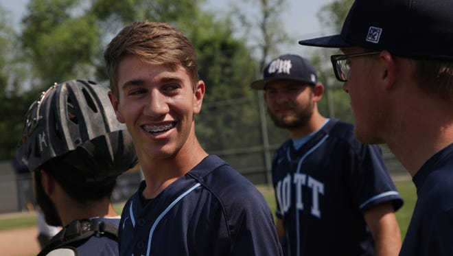 Waterford Mott senior Grant Johnson, left, talks with his coach Collin McGran before a game against Lake Orion in Clarkston on May 29, 2018.
Johnson was hit in the middle of the face by a baseball during a game May 8 that resulted in a grade-three concussion and a broken nose and bone on his cheek.