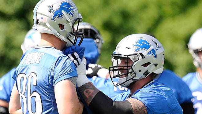 Lions rookie tackle Taylor Decker, right, works against rookie tight end Adam Fuehne during offensive line drills at OTAs.