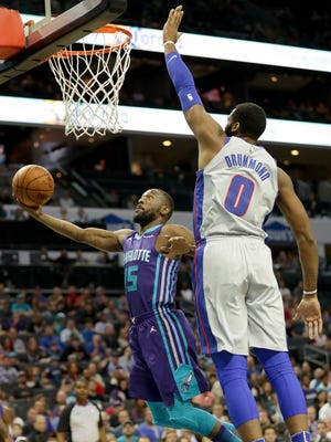 Kemba Walker drives to the basket against Andre Drummond on Sunday.