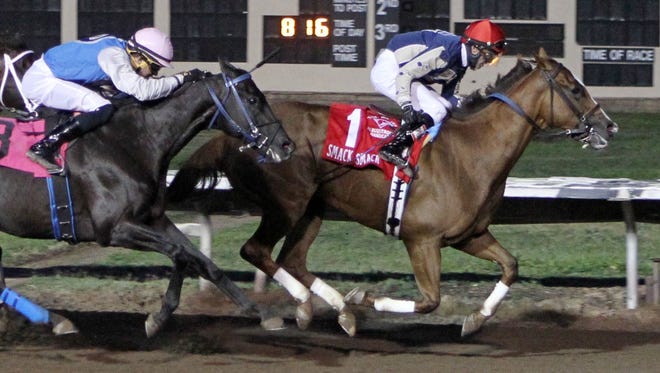 Jockey Shane Laviolette guides post-time favorite Smack Smack to victory in Saturday's $175,000 Downs at Albuquerque Handicap, finishing just ahead of a fast closing Forest Mouse and jockey Ry Eikleberry.