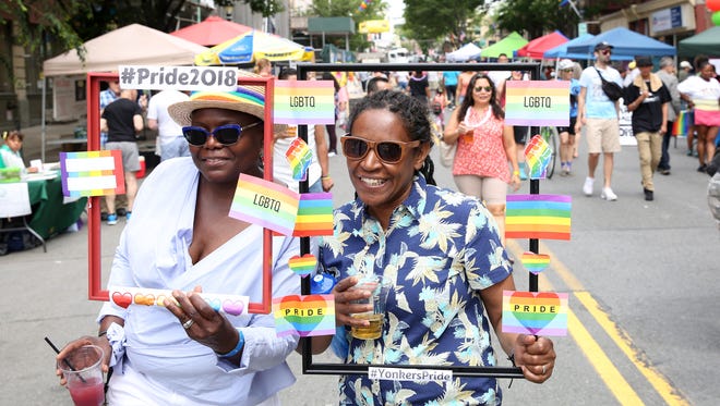 From left, Shelly Burns Torres and Carmen Torres enjoy the festivities during the Yonkers Pride Day celebration along Main Street in downtown Yonkers June 9,  2018. 