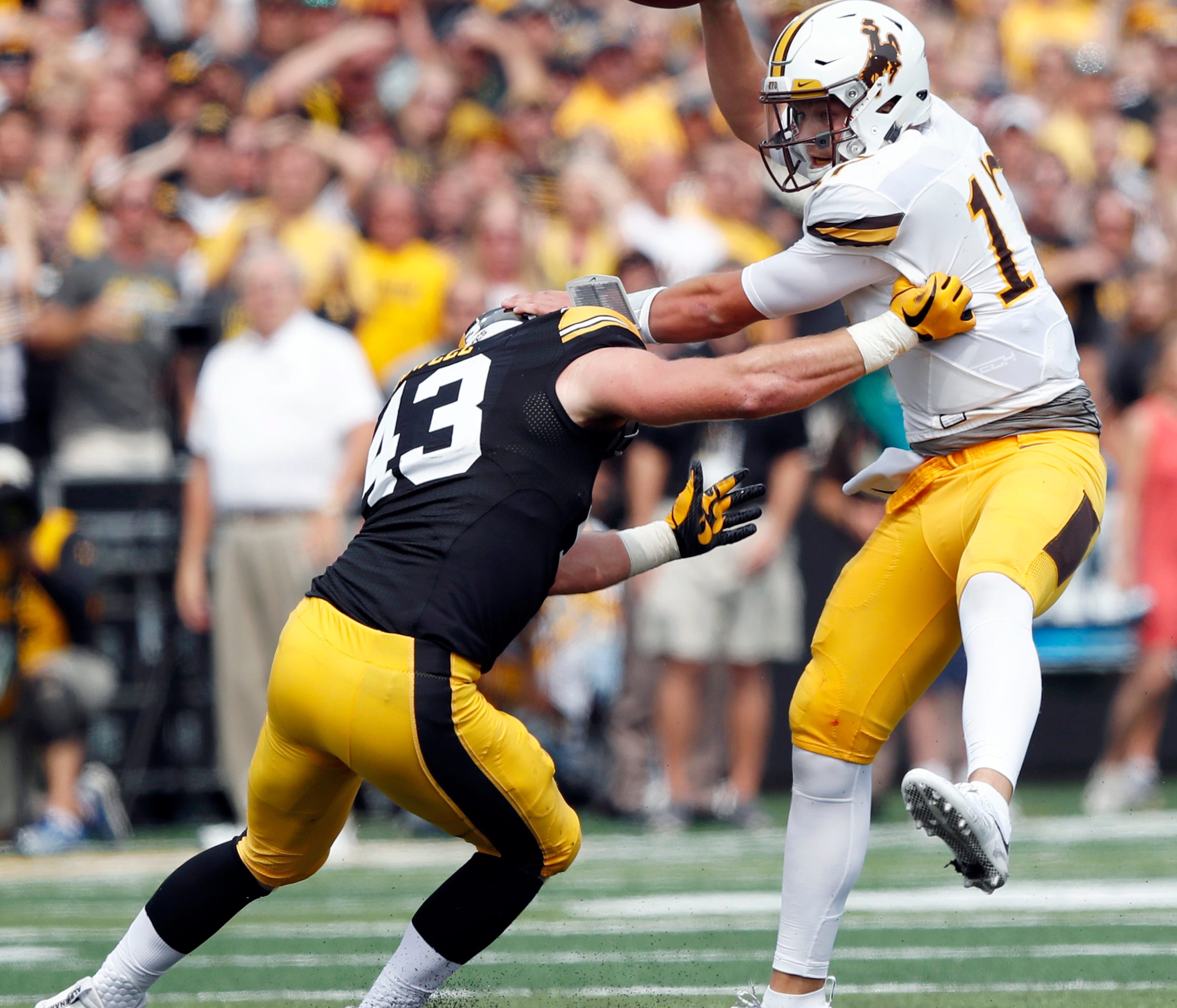 Wyoming quarterback Josh Allen is sacked by Iowa linebacker Josey Jewell, left, during the first half of an NCAA college football game, Saturday, Sept. 2, 2017, in Iowa City, Iowa. (AP Photo/Charlie Neibergall)