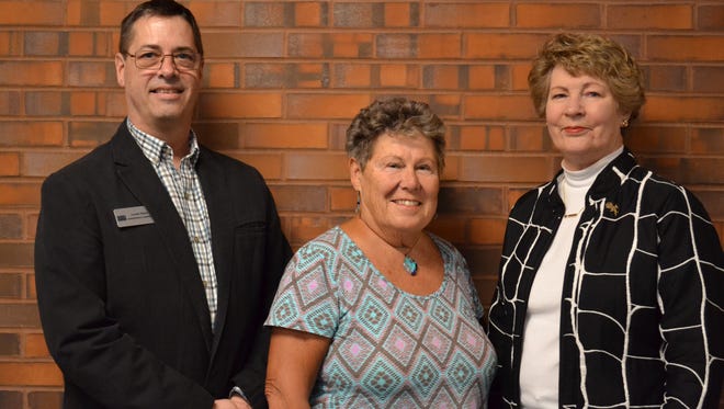 Lonnie Shuey, Administrative Coordinator of the Terra College Foundation, stands with Parm Boyer, center, and Ellen Honsperger of the Gold Diggers investment club.