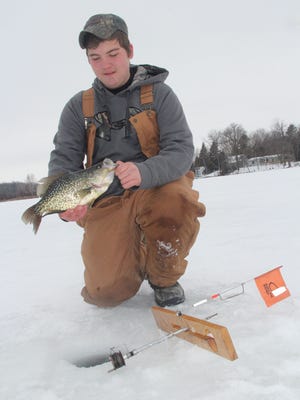 Tate Maurer, an eighth-grader from Waupaca, holds a 14.5-inch crappie he caught ice fishing during the Kettle Moraine Tip-Up Extravaganza in January near Dundee.