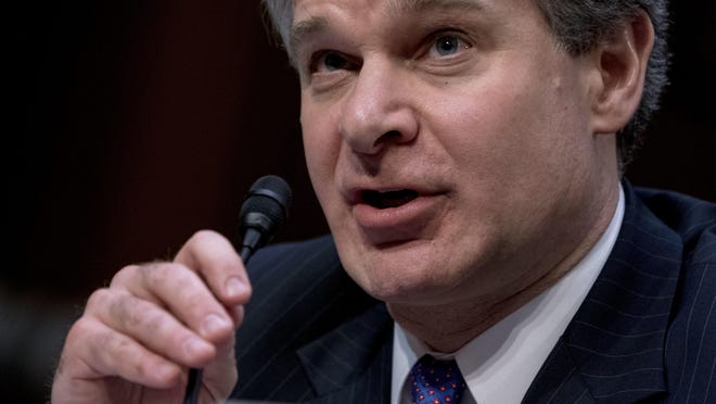 FBI Director Christopher Wray speaks during a Senate Select Committee on Intelligence hearing on worldwide threats, Tuesday, Feb. 13, 2018, in Washington. Wray said the agency provided the White House with information twice last year about Rob Porter, the top Trump aide who resigned as staff secretary last week after domestic violence allegations from two ex-wives became public. Wray said the bureau closed its background investigation on Porter in January, weeks before the allegations were published. (AP Photo/Andrew Harnik)