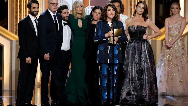 Jill Soloway, foreground, accepts the award for best TV series, comedy or musical for "Transparent" at the 72nd Annual Golden Globe Awards.