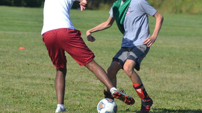 Cheboygan varsity boys soccer players battle for the ball during a practice at Gordon Turner Park on Wednesday. Following the MHSAA's ruling on Thursday, sports such as boys soccer and volleyball were given the go-ahead to play competitive games. Cheboygan will host Sault Ste. Marie in its season opener at 5 p.m. on Monday.