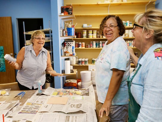 Connie Whitlock (left) teaches a ceramics class with