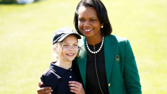 Former United States Secretary of State and Augusta National member Condoleezza Rice wearing the green jacket hugs Lydia Swan from North East, PA, after winning the 10-11 Girls Division at the Drive, Chip & Putt National Finals at Augusta National Golf Club.