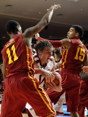 Oklahoma Sooners forward Ryan Spangler (00) drives against Iowa State Cyclones guard Monte Morris (11) and guard Naz Long (15) during the second half of a 2014 game at Lloyd Noble Center. Oklahoma beat Iowa State 87-82. The Sooners have won nine of their last 10 games at home against the Cyclones.