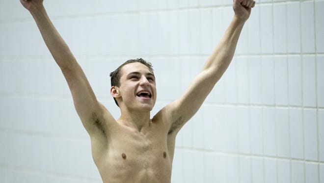 Isaac Khamis, Richmond High School, acknowledges the crowd during his second place come-from-behind diving effort, IHSAA Boys Swimming and Diving Finals, IUPUI Natatorium, Indianapolis, Saturday, Feb. 27, 2016.