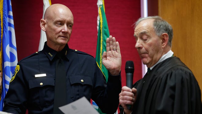 Judge Donald Zuidmulder swears in Andrew Smith as the new Green Bay Police Chief in the City Council chambers in Green Bay on Monday.