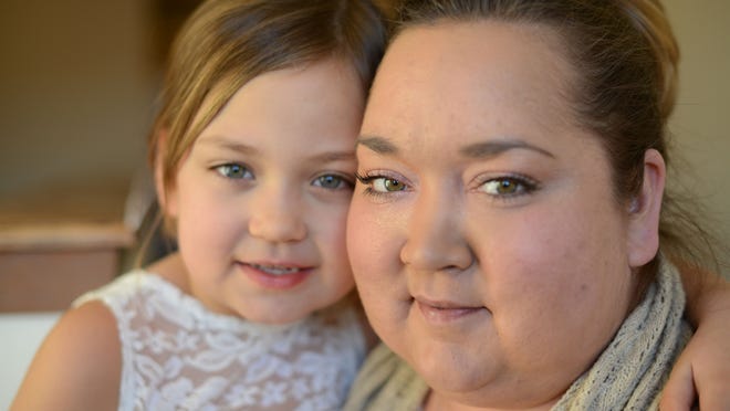 Mandy Chartier, right, and her daughter Emma at home in Ashwaubenon on Feb. 26. Mandy is a single mom with brain cancer and due to her medical treatment she has been unable to work.