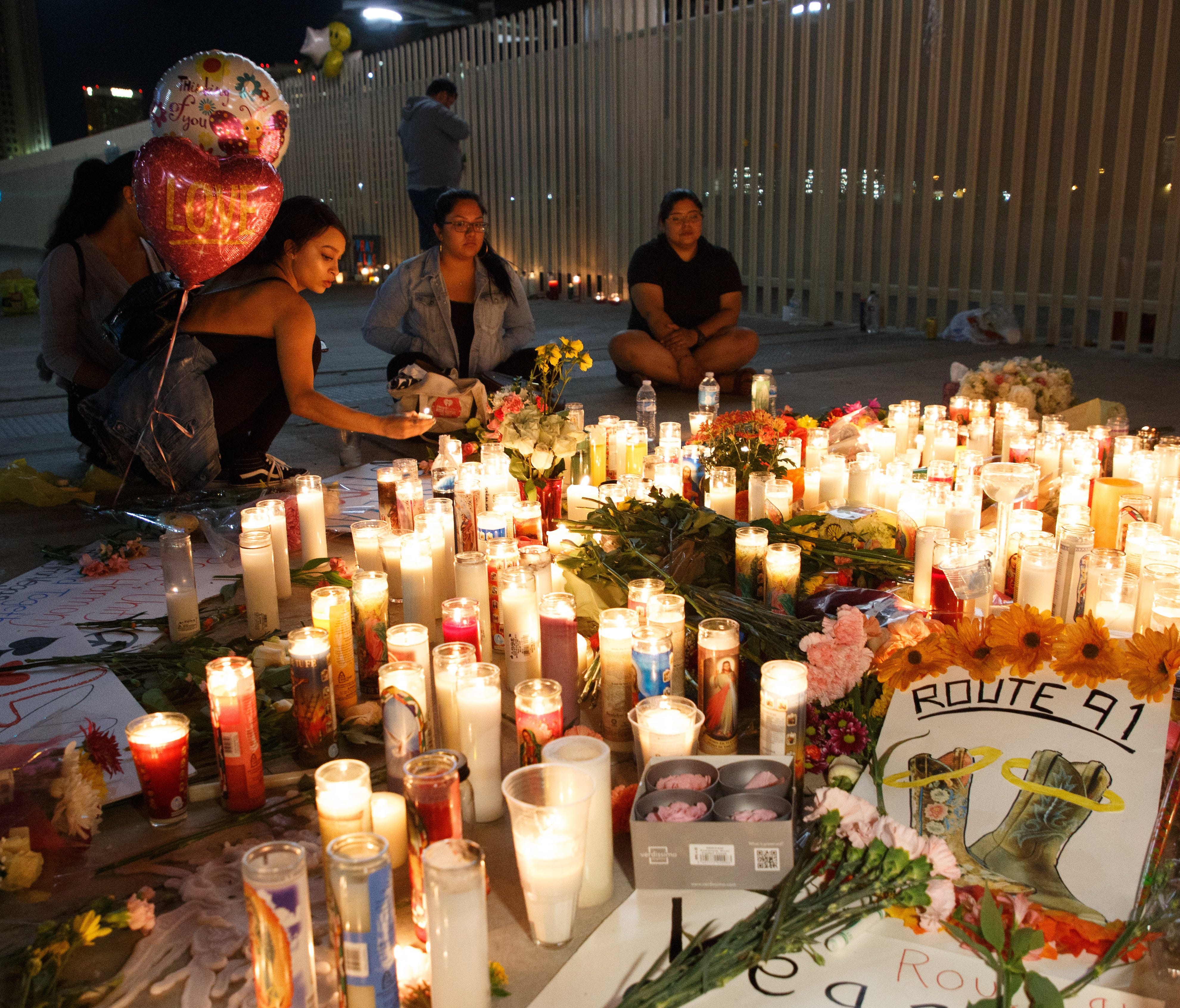 Mourners pay tribute at a makeshift memorial on the Las Vegas Strip for the victims of a mass shooting in Las Vegas on Monday.