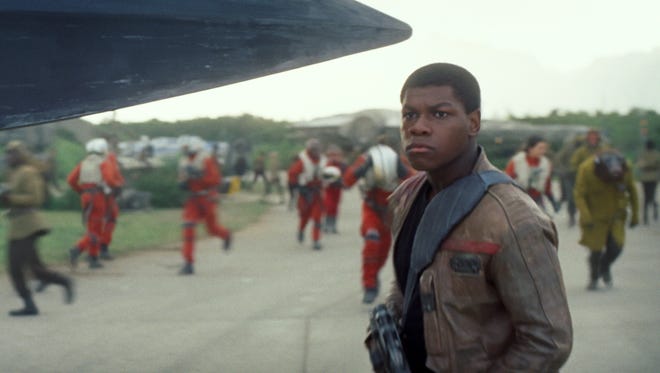 This photo provided by Disney shows John Boyega as Finn, in a scene from the new film, "Star Wars: The Force Awakens," directed by J.J. Abrams. The movie releases in the U.S. on Friday, Dec. 18, 2015. (Film Frame/Disney/Lucasfilm via AP)