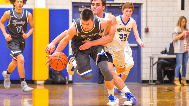 Wyoming sophomore Joey Edmonds gets fouled by Nick Ramos of Madeira.