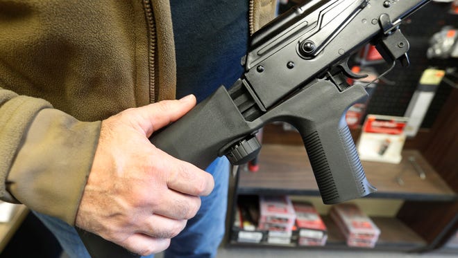 bump stock device, (left) that fits on a semi-automatic rifle to increase the firing speed, making it similar to a fully automatic rifle, is installed on a AK-47 semi-automatic rifle, (right) at a gun store on October 5, 2017 in Salt Lake City, Utah. Congress is talking about banning this device after it was reported to have been used in the Las Vegas shooting.
