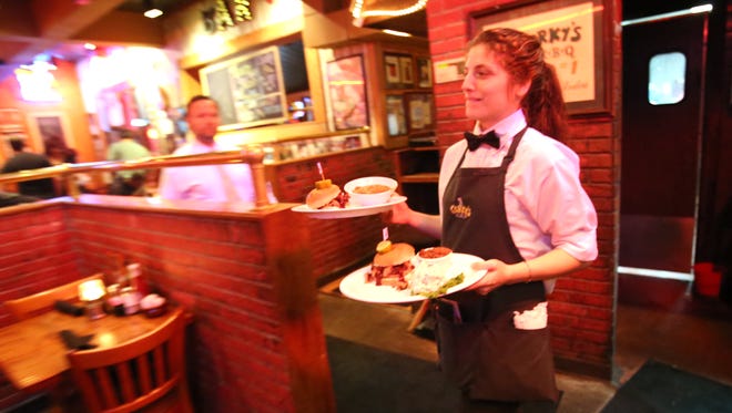 October 18, 2016 - Devin Rogers serves up lunch to customers at Corky's. Officials at the local chain have scheduled a job fair to fill 50 positions in its restaurant, catering and frozen-food shipping operations.